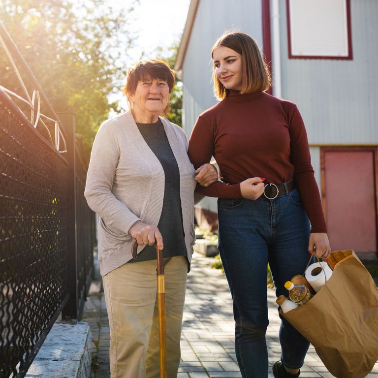 a home care person helping old lady